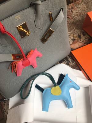Hermès, three leather bag charms, 'Rodeo' and 'Paddock'. - Bukowskis